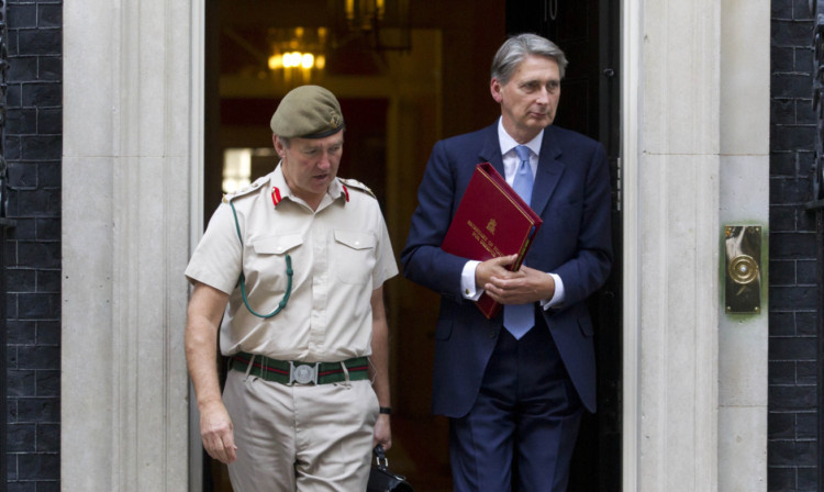 Defence Secretary Philip Hammond (right) and Chief of Defence Staff General Sir Nicholas Houghton leave 10 Downing Street.