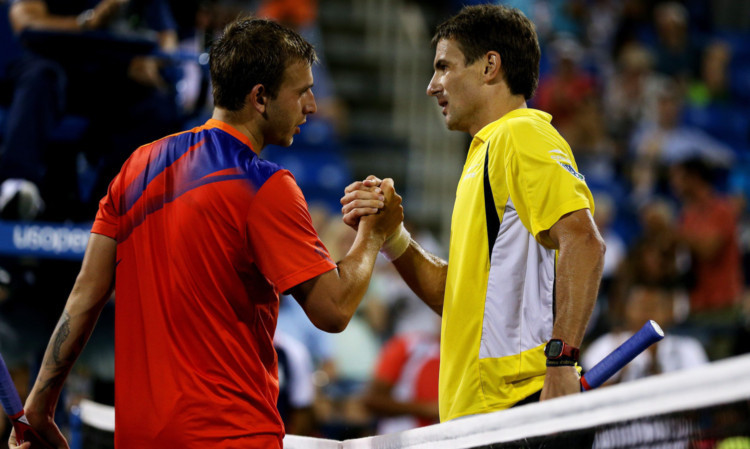 Dan Evans shakes hands with Tommy Robredo after his defeat.