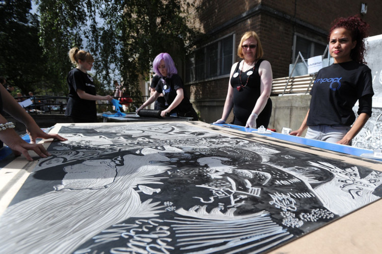 A three-tonne road roller put the finishing touches to 10 new artworks celebrating Dundees history, culture and landscape to bring the inaugural Print Festival Scotland (PFS) to a dramatic conclusion on Saturday. The Big Print brought professional artists, students and local school and community groups together to create a series of 190cm x 90cm lino tiles inspired by themes as diverse as the demolition of Tayside House, pioneering social reformer Mary Lily Walker and urban foxes. The volunteers congregated in the car park of Duncan of Jordanstone College of Art and Design to see a road roller print the designs on to paper in front of crowds of people. The resulting 10 new artworks will go on display in the creative learning suite at the McManus to coincide with the Modern Masters in Print Exhibition.