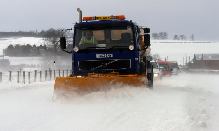 A snow plough trying trying to clear a path for drivers on the B961.