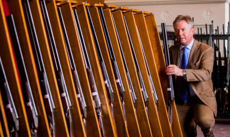 Gavin Gardiner inspects some of the modern and vintage guns.