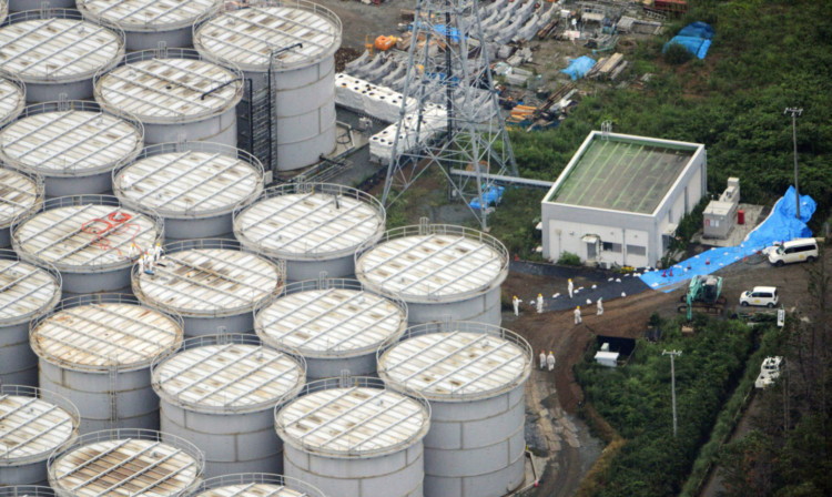 Workers checking storage tanks at the Fukushima Dai-ichi nuclear plant.