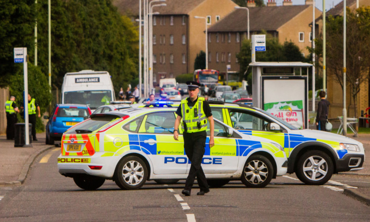 Police directing traffic away from the scene after the accident.