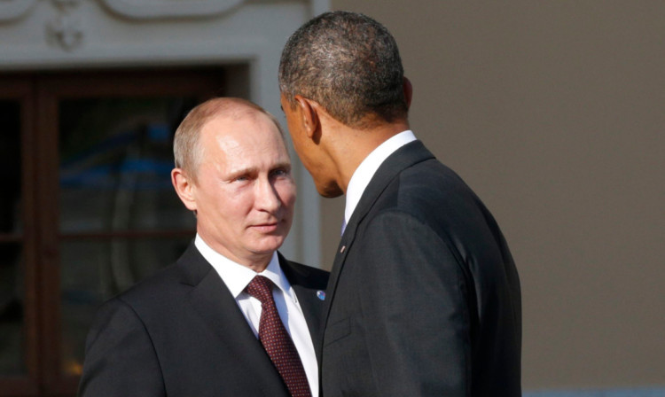 US President Barack Obama speaks with Russian President Vladimir Putin at the start of the G20 summit in St Petersburg.