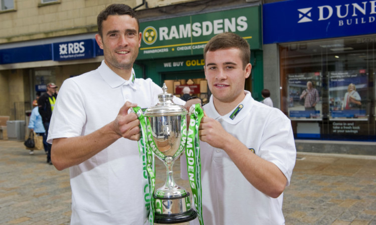Raith pair Laurie Ellis, left, and Lewis Vaughan get their hands on the trophy.