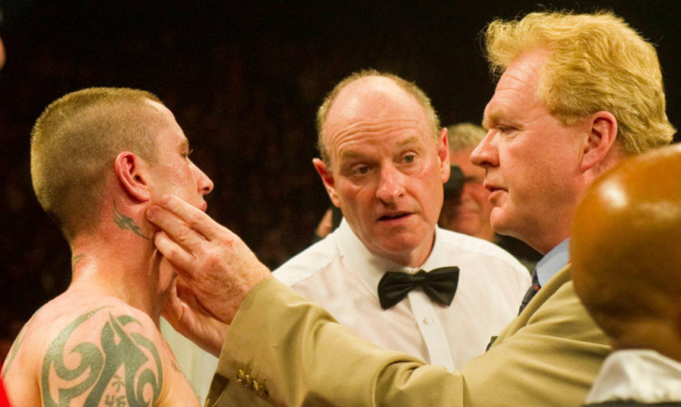 A doctor inspects Ricky Burns' jaw after the fight.