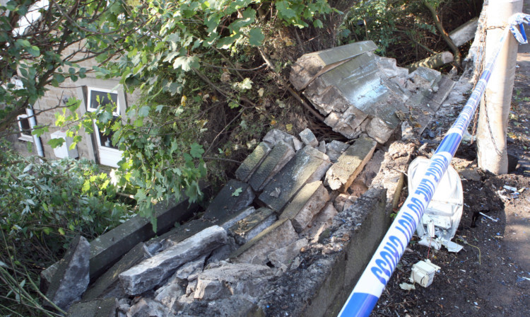 The crash sent large blocks falling down into a garden.