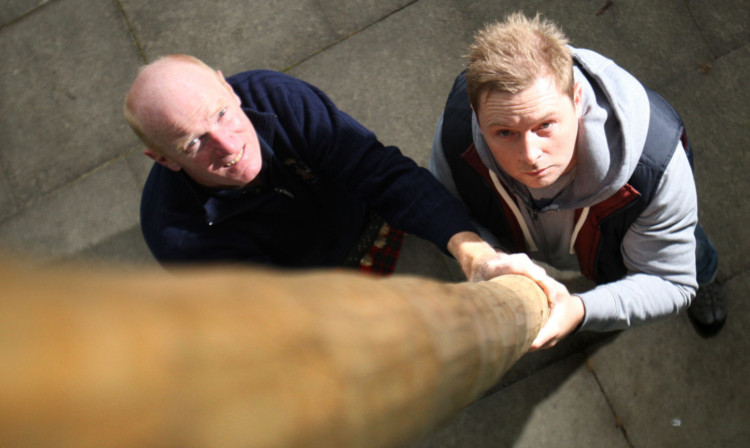 Courier reporter Peter Swindon tried his hand at caber tossing, under the watchful eye of Raymond McIntosh.