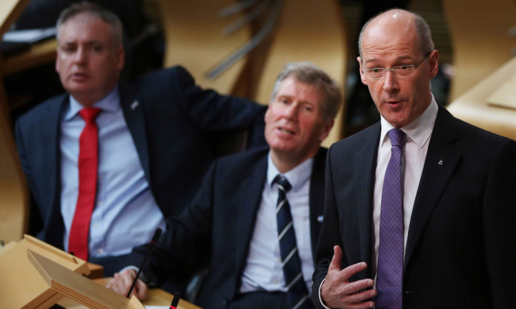 Finance Secretary John Swinney detailed his draft budget for 2014-15 to MSPs at Holyrood.