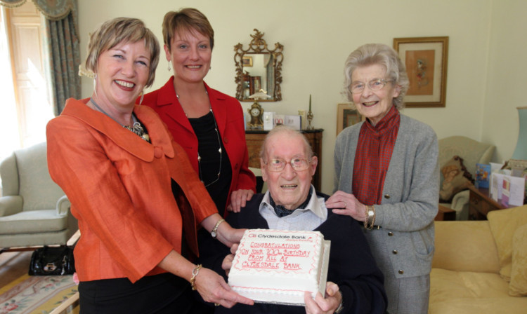 Clydesdale Bank banking partner Jackie Campbell and private associate Sharon Farquharson congratulating Mr Reekie and his wife Elizabeth on his 100th birthday.