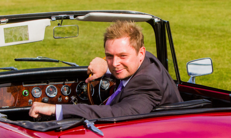 Courier reporter Peter Swindon at the wheel of a 1967 Sunbeam Alpine.