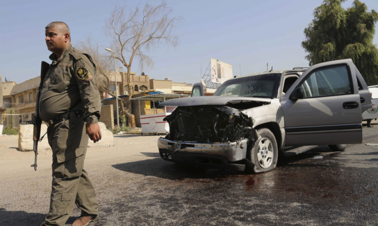 A policeman at the scene of a blast in Baghdads northern Azamiyah neighbourhood.