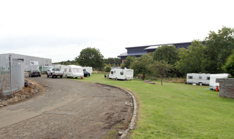 Travellers outside the gate of the former Sella factory, Nobel Road, Wester Gourdie Industrial Estate, and some inside the gate.