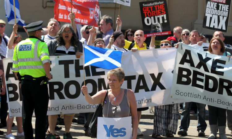 Sleeper hit: protesters demonstrate their opposition to the bedroom tax in Kings Park, Stirling.