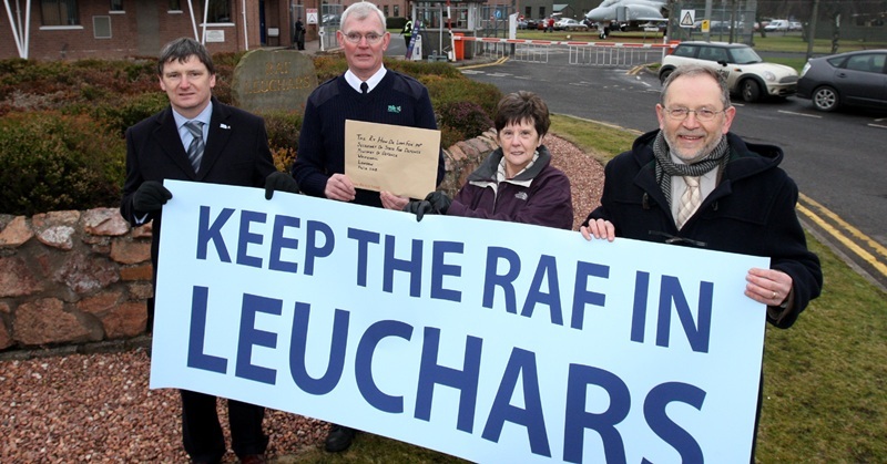 Steve MacDougall, Courier, Main Gate RAF Leuchars. Save Base Petition being handed over to courier for transit to London. Pictured, left to right is Councillor Peter Grant , Jim Lawson (Fife Council, Courier), Carroll Finnie (Chair of Leuchars Community Council) and Councillor Tim Brett.