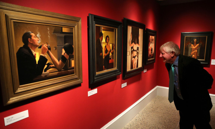 David Roberts views the painting The Opening Gambit (centre)  by Jack Vettriano at the Kelvingrove Art Gallery in Glasgow.