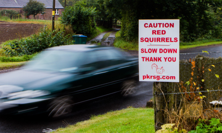 Residents have erected new signs asking drivers to slow down.