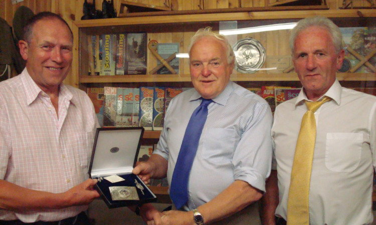 Ivan Laird (centre) receives the presentation from South Angus District Commissioner Stewart Duff, with North Angus District Commissioner Willie Bell (right) looking on.