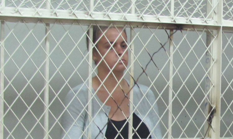 Melissa Reid stands in a holding cell during her hearing.