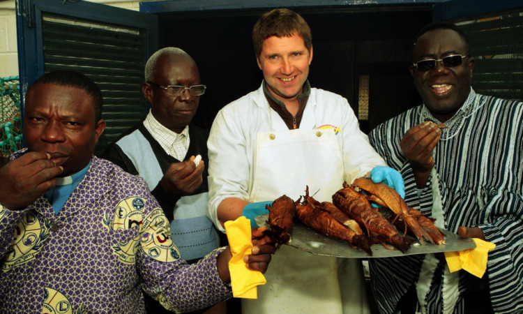 Tam Swankie lets his Ghanaian visitors try some smokies  although some look keener than others!