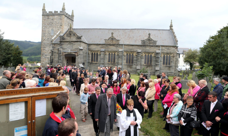 The family of April Jones and mourners follow her coffin out of St Peter's Church, Machynlleth, after her funeral service.