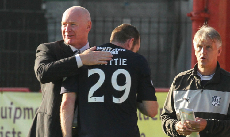 Craig Beattie is congratulated by his manager.