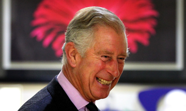 The Duke of Rothesay speaks with volunteers during a tour of Clan Cancer Support in Aberdeen.