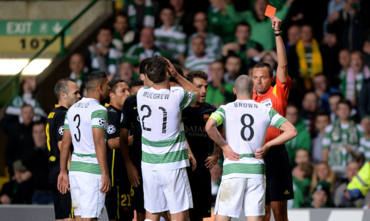 Referee Stephane Lannoy shows Scott Brown red for kicking out at Neymar.