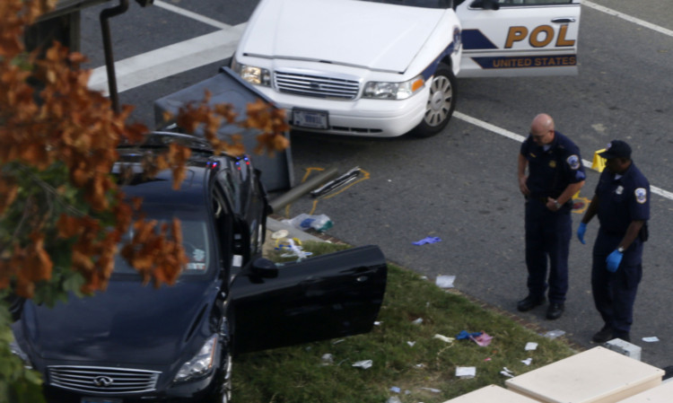 Police beside the woman's car after the fatal shots were fired.