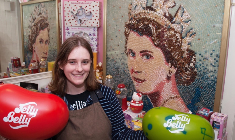Shop assistant Sophie Bodington with the jelly bean portrait of the Queen.