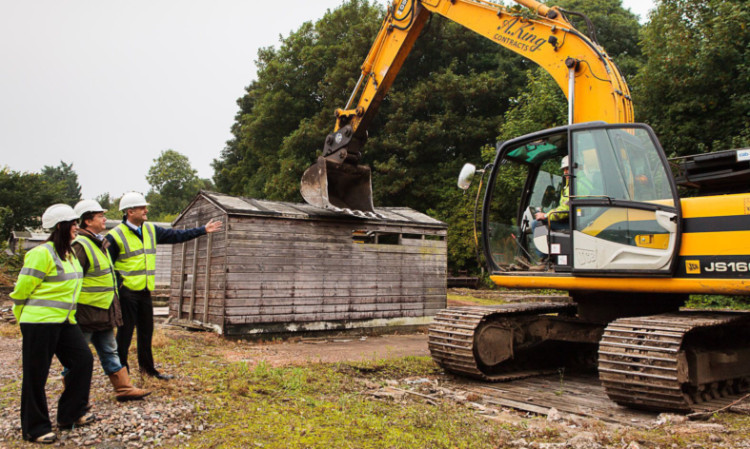 Barnetts chairman Paul Barnett (third left) gives the signal for demolition of one of the garages on the site, watched by Fife Council economic adviser Lesley Brown, and Sayak UK director Gordon Murray.