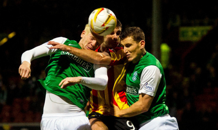 Kris Doolan, centre, battles for the ball with Hibs pair Ryan McGivern and Paul Hanlon, right.