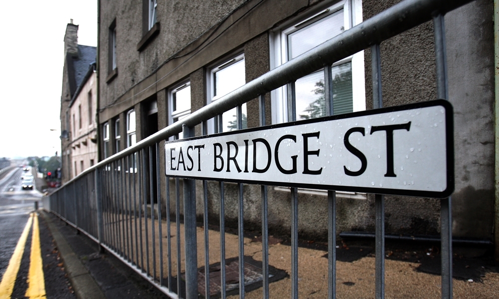 Kris Miller, Courier, 04/10/13. Picture today shows the East Bridge Street sign where houses are going to have to be demolished due to an unsafe wall.