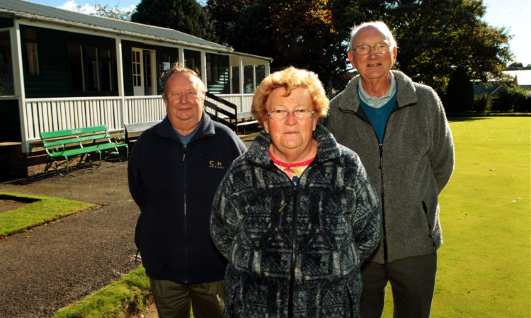 Bowling club committee members (from left) Vice President Colin Wilson, Treasurer Cath Evans and President Kenneth Marbelley outside the clubhouse.
