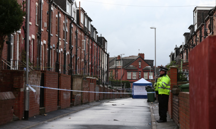 Police at the scene in Back Hill Top Avenue in the Harehills area of Leeds.