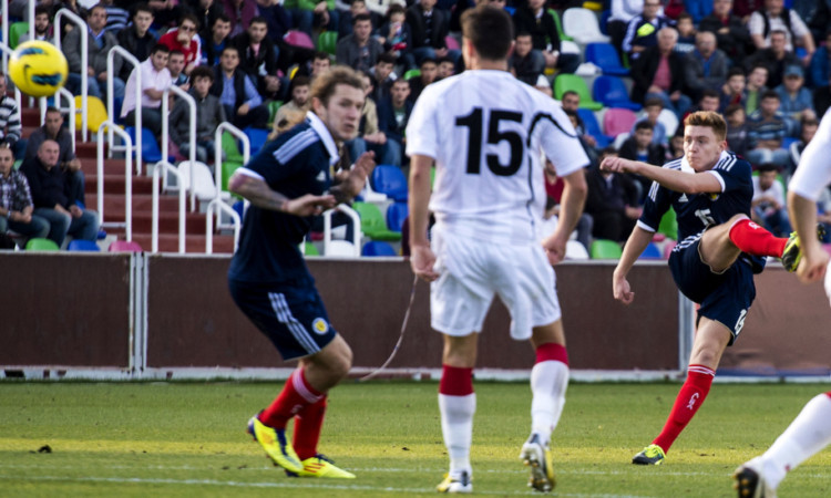 Lewis MacLeod (right) rifles a volley home to pull a goal back for Scotland.