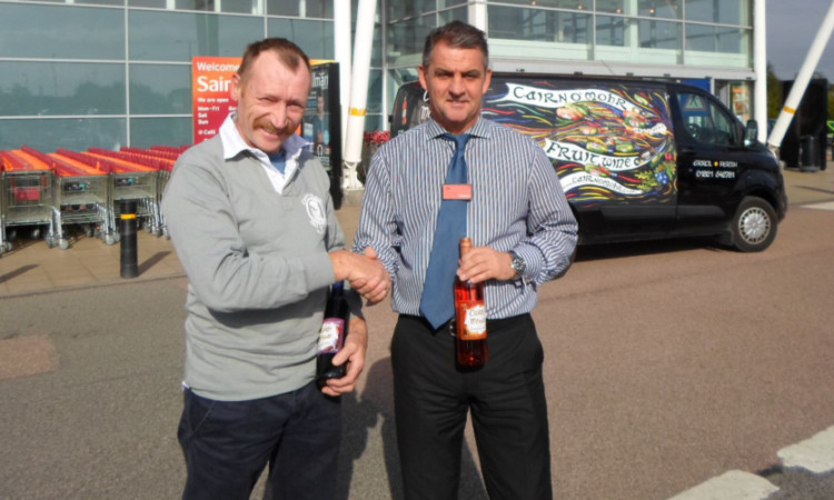 Ron Gillies of Cairn OMohr and Jim Burton, deputy manager at Sainsburys, Dundee. The fruit wine will be stocked in 30 Sainsburys stores in Scotland.