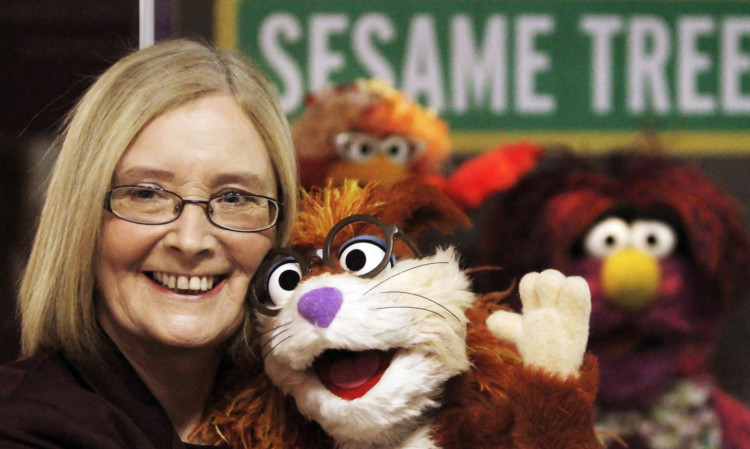 Holyrood Presiding Officer Tricia Marwick with characters from Sesame Street during the opening of the exhibition.
