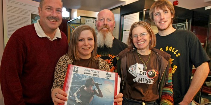 Kim Cessford, Courier - 30.10.10 - Kirriemuir celebrated Bon Scott with a weekend of events - pictured in the Gateway to the Glens Museum are l to r - Neil McDonald (who lent part of his AC/DC collection to the museum), Victoria Melton (DD8 Music), David Hickey (fan), Ellie Fiddes (DD8 Music) and Daniel Hickey (fan)