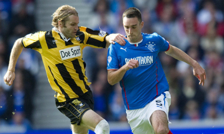 Robbie Neilson up against Lee Wallace during the defeat at Ibrox earlier this season.