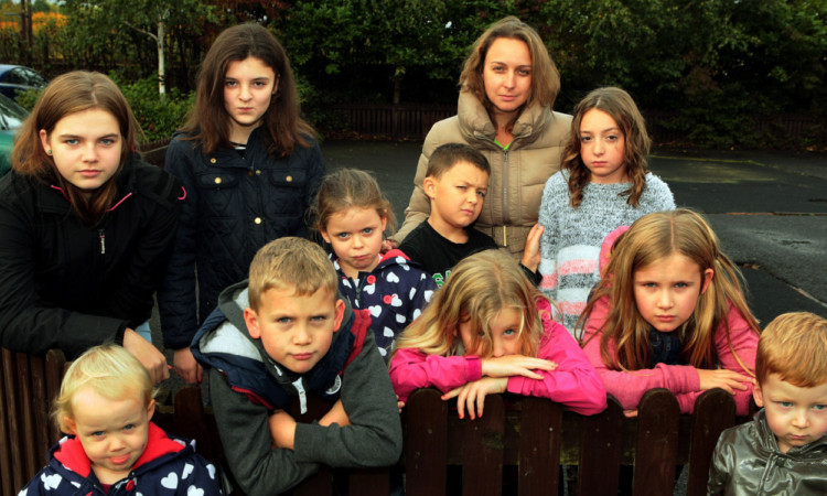 Fi Penman with some of the children in the playpark which the council is demolishing.