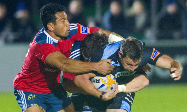 Munster duo Casey Laulala and Mike Sherry challenge Chris Cusiter.