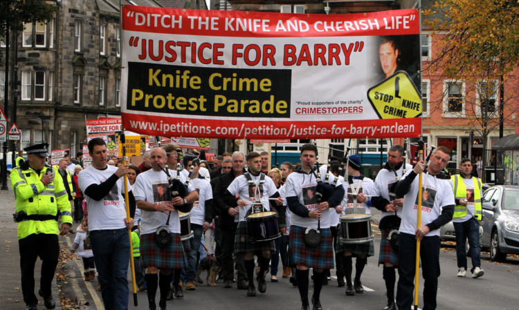 The Justice For Barry march heads along the High Street in Burntisland, led by the McLean family.