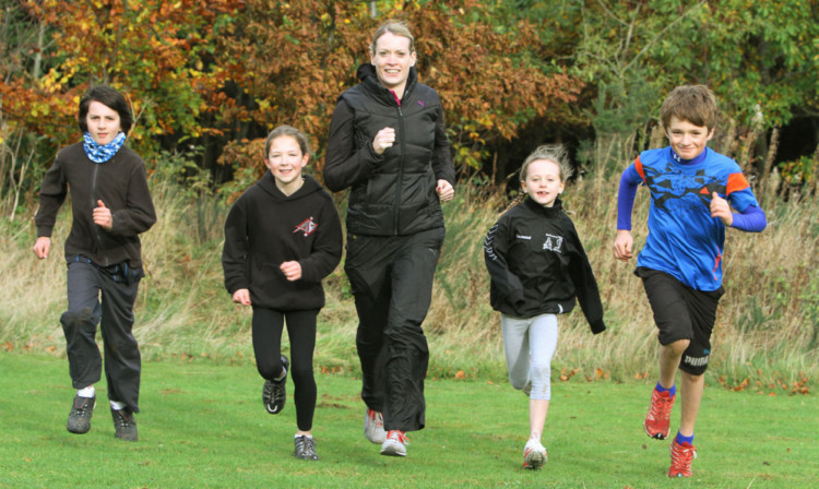 Athlete Eilidh Child at Falkland Estate with, from left, Elliot Mair, Naimh Crofts, Ailidh Forbes and Joe Christey, all from Falkland Primary School.