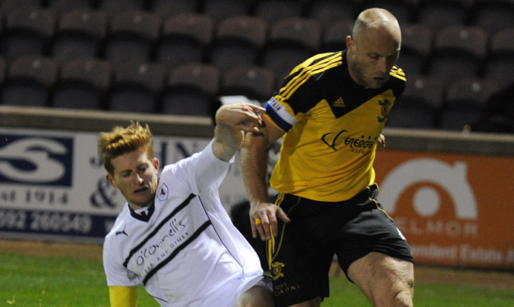 Raith's Jason Thomson challenges Simon Mensing.