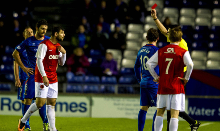 Uniteds Nadir Ciftci is shown the red card by referee Kevin Clancy.