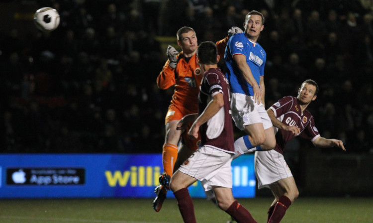 Jon Daly gets in front of Stenhousemuir goalkeeper Chris Smith to head in Rangers winner.