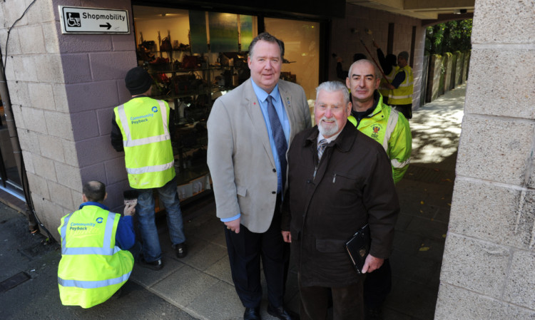 In Ropemakers Close, off South Street, Perth, with some of the people who are serving a community payback order, are, from left, Councillor Douglas Pover, Councillor Jack Coburn and Scott Bryson, community payback supervisor.