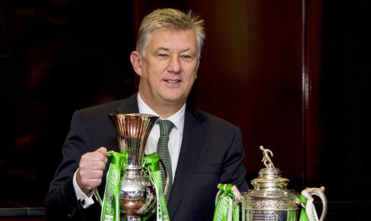 Celtic chief executive Peter Lawwell with the Scottish Cup and a specially commissioned trophy to mark their victory last season.