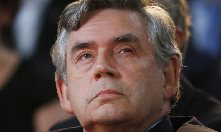 Gordon Brown described himself as an "ex-politician" during a summit in Qatar.